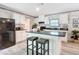 Modern kitchen featuring an island with seating, white cabinets, and stainless steel appliances at 6189 Nw 68Th St, Ocala, FL 34482