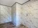 A clean and functional laundry room with marbled wall paneling and wood-style flooring at 6189 Nw 68Th St, Ocala, FL 34482