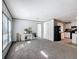 Bright living room with plush carpet, neutral walls, and a view into the adjacent kitchen at 6189 Nw 68Th St, Ocala, FL 34482