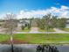 Aerial view of homes with well-manicured lawns and brick driveways in a lakeside community at 6441 Point Hancock Dr, Winter Garden, FL 34787