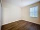 Bedroom with hardwood floors, a neutral color palette, and a window allowing natural light at 6441 Point Hancock Dr, Winter Garden, FL 34787