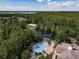 Aerial view of the community pool with a covered pavilion and lakeside views at 6441 Point Hancock Dr, Winter Garden, FL 34787