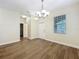 Well-lit dining room featuring hardwood floors and a contemporary chandelier, enhancing the home's appeal at 6441 Point Hancock Dr, Winter Garden, FL 34787