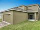 Home exterior showcasing a two-car garage, siding and a green lawn at 6441 Point Hancock Dr, Winter Garden, FL 34787