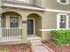 Home exterior featuring a black front door with brick walkway and neatly trimmed landscaping at 6441 Point Hancock Dr, Winter Garden, FL 34787