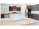 Well-equipped kitchen featuring granite countertops, stainless steel appliances, and dark wood cabinets at 6441 Point Hancock Dr, Winter Garden, FL 34787