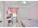 Pink bedroom features a bed, desk, and window with bright light at 6921 Long Needle Ct, Orlando, FL 32822