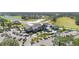 Aerial view of the clubhouse with its elegant design, well-kept grounds, and extensive parking at 732 Aldenham Ln, Ormond Beach, FL 32174