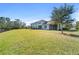 Expansive backyard featuring a lush lawn, mature trees, and a view of the home's screened patio perfect for outdoor living at 732 Aldenham Ln, Ormond Beach, FL 32174