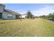 View of backyard featuring a lawn leading to the neighboring townhome properties at 732 Aldenham Ln, Ormond Beach, FL 32174