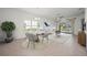 Bright dining area open to a living space, with a round table, modern chairs, and natural light at 732 Aldenham Ln, Ormond Beach, FL 32174