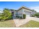 Charming home featuring stone accents, a two-car garage, and a well-manicured lawn with fresh landscaping at 732 Aldenham Ln, Ormond Beach, FL 32174