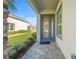 Welcoming front entrance with a stylish glass paneled door, clean pavers, and freshly trimmed landscaping at 732 Aldenham Ln, Ormond Beach, FL 32174