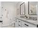 Elegant bathroom featuring double vanities with granite countertops and modern fixtures at 747 Citrus Isle Dr, Davenport, FL 33837