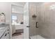 Modern bathroom with a tiled shower and doorway to the main bedroom at 747 Citrus Isle Dr, Davenport, FL 33837