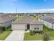 Single-story home showcasing manicured lawn and complemented by a well-kept yard in a suburban neighborhood at 747 Citrus Isle Dr, Davenport, FL 33837