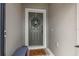 Stylish gray front door with decorative wreath, welcome mat and bench for guests at 747 Citrus Isle Dr, Davenport, FL 33837