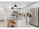 Modern kitchen with stainless steel appliances, granite countertops, and white cabinets at 747 Citrus Isle Dr, Davenport, FL 33837