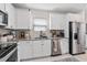 Modern kitchen featuring stainless steel appliances, stone countertops and white cabinets at 747 Citrus Isle Dr, Davenport, FL 33837