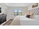 Bright main bedroom featuring a tufted headboard and view of the backyard at 747 Citrus Isle Dr, Davenport, FL 33837