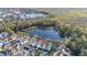 An aerial shot shows the property backing to a lake in a beautiful residential neighborhood at 826 Lake Evalyn Dr, Celebration, FL 34747