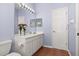 Bathroom featuring a double sink vanity, neutral walls, and decorative flowers, creating a serene atmosphere at 826 Lake Evalyn Dr, Celebration, FL 34747