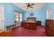 Bright bedroom with blue walls, wood furniture, and cozy carpet at 826 Lake Evalyn Dr, Celebration, FL 34747