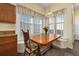 A breakfast nook features large windows, built in bench seating, and a wood table at 826 Lake Evalyn Dr, Celebration, FL 34747