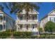 Charming two-story home with a double front porch, white railings, and manicured landscaping at 826 Lake Evalyn Dr, Celebration, FL 34747