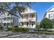 Charming two-story home with a double front porch, white railings, and well-maintained landscaping at 826 Lake Evalyn Dr, Celebration, FL 34747