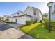 Exterior view of townhome featuring manicured lawn and attached garage at 826 Lake Evalyn Dr, Celebration, FL 34747