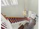 Bright entryway showcasing a pendant light fixture and red carpeted stairs at 826 Lake Evalyn Dr, Celebration, FL 34747