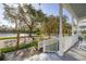 Inviting front porch features a white picket fence and a scenic view of the neighborhood lake at 826 Lake Evalyn Dr, Celebration, FL 34747