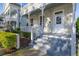 Inviting front porch featuring steps leading to the door and well-manicured landscaping at 826 Lake Evalyn Dr, Celebration, FL 34747