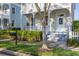 Inviting front porch with steps leading to the door, a trimmed hedge, and a mailbox at 826 Lake Evalyn Dr, Celebration, FL 34747