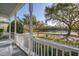 Inviting front porch features a white picket fence and a scenic view of the neighborhood lake at 826 Lake Evalyn Dr, Celebration, FL 34747