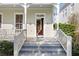 Welcoming front porch with staircase view into the home's foyer, featuring classic architectural details at 826 Lake Evalyn Dr, Celebration, FL 34747