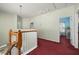 Upstairs hallway with doors leading to bedrooms, carpet flooring, and light-colored walls at 826 Lake Evalyn Dr, Celebration, FL 34747