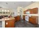 Open kitchen with a center island, tile flooring, and breakfast bar connecting the dining area at 826 Lake Evalyn Dr, Celebration, FL 34747