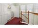 Upper-level laundry room near the staircase features washer, dryer, and storage at 826 Lake Evalyn Dr, Celebration, FL 34747