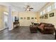 A living room featuring a leather couch, a trunk style coffee table, and warm lighting at 826 Lake Evalyn Dr, Celebration, FL 34747