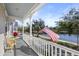 Charming porch view overlooking a peaceful lake and neighborhood at 826 Lake Evalyn Dr, Celebration, FL 34747