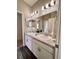 Bathroom with double vanity, granite countertops and a large mirror at 870 Galloway St, Lake Alfred, FL 33850