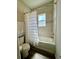 Clean bathroom featuring a tiled shower and a white shower curtain at 870 Galloway St, Lake Alfred, FL 33850