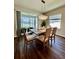 Dining room featuring a modern chandelier, wood table, and large sliding glass doors at 870 Galloway St, Lake Alfred, FL 33850