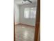 Bedroom featuring neutral walls, a ceiling fan, window with blinds and wood-look flooring at 888 Berkley Rd, Auburndale, FL 33823