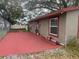 Angled side view of home showing windows, door, landscaping and stucco exterior at 888 Berkley Rd, Auburndale, FL 33823