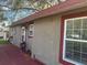 Exterior daytime view of a house with a red trim door and window at 888 Berkley Rd, Auburndale, FL 33823