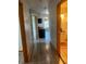 Hallway with wood-look floors leading to the kitchen, living room, and bathroom at 888 Berkley Rd, Auburndale, FL 33823