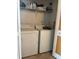 A laundry room with a washer and dryer unit and shelving space at 888 Berkley Rd, Auburndale, FL 33823